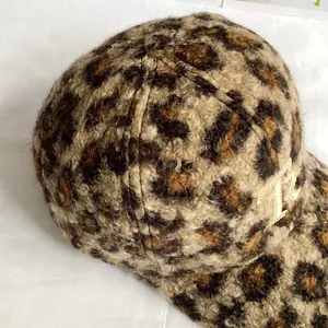 Detail of plush leopard print baseball cap with gold NY embroidery and fuzzy texture