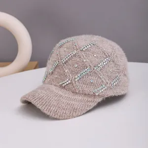 Detail of knitted baseball cap in dusty pink with sparkling rhinestones and plush texture