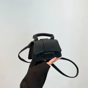 French style black woven hourglass handbag with top handle and crossbody strap