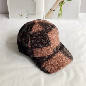 Close-up of color-block teddy fleece baseball cap with thick warm textured lamb wool fabric