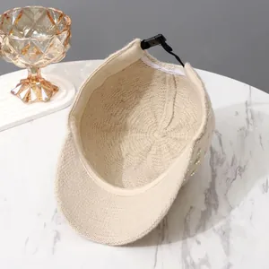 Detailed interior of a beige knitted baseball cap featuring an adjustable back strap