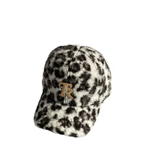 Winter baseball cap in black and white leopard teddy fur with golden TR embroidery