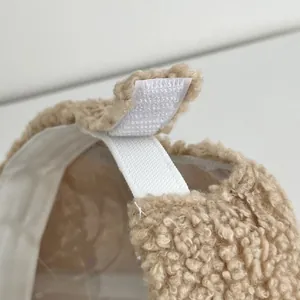Detail of soft lamb wool fabric with adjustable elastic strap and velcro closure