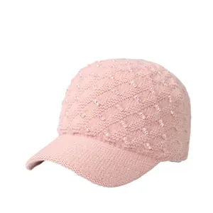 Light pink knitted baseball cap with sparkling rhinestone accents for winter warmth