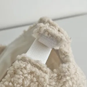 Detail of warm lamb wool fabric texture with velcro closure on the back of the beige cap