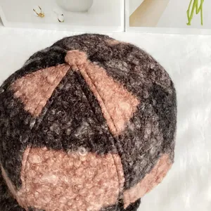 Detailed macro view showing the textured pink and grey teddy fleece plaid baseball cap