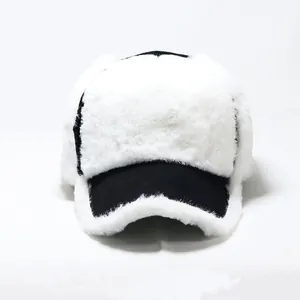 Detailed view of the thick white plush baseball cap with stylish black trim for winter