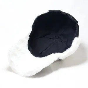 Close-up of winter baseball cap showing white faux fur earflaps and soft black inner lining
