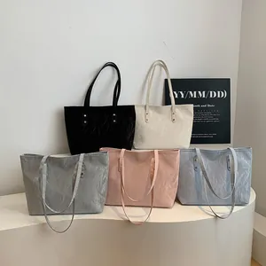 Minimalist textured tote bags in five colors with large capacity and gold rivet accents