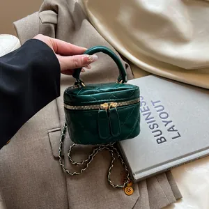 Deep green quilted mini box bag with gold chain strap and top handle for women