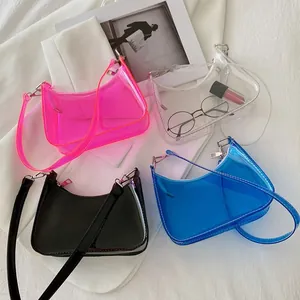 Flat lay of colorful clear PVC jelly shoulder bags in pink, white, black and blue