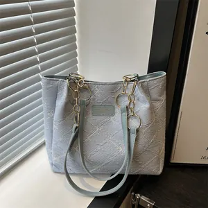 Light blue floral canvas tote bag with jacquard pattern and leather shoulder strap