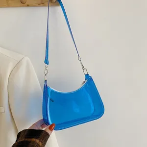 Detail of blue transparent PVC shoulder bag with silver metal hooks and white zipper