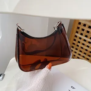 Detail shot of a transparent amber jelly bag featuring black zipper and silver metal hooks