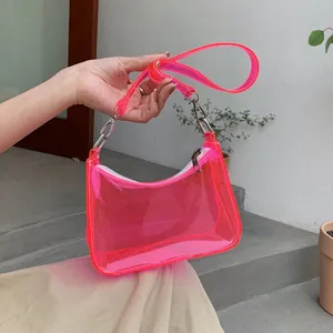 Detail of neon pink transparent PVC shoulder bag with white zipper and silver metal hardware