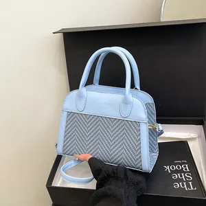 Light blue contrast-colored tote bag with textured weaving and top handles in gift box