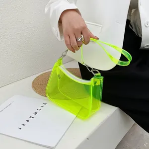 Detailed shot of neon green transparent PVC bag with white zipper and metal hooks