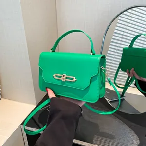 Chic grass green square flap handbag with gold metal lock and adjustable shoulder strap
