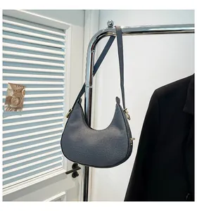 Detail of grey-blue woven canvas hobo bag with silver metal buckle and strap hook