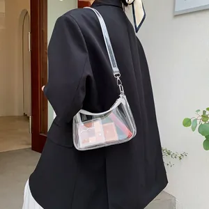 Detailed view of clear PVC hobo bag with white zipper and wide shoulder strap