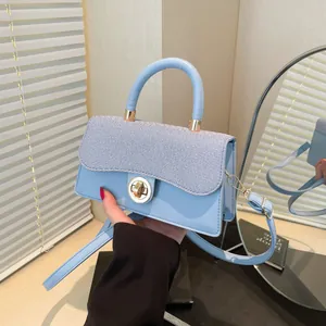 Light blue mini handbag with textured paneling and golden metal buckle for women