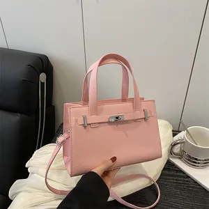 Elegant light pink lychee pattern top-handle bag with adjustable strap and metal lock