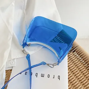 Detailed macro view of the blue translucent PVC crescent bag with white zipper and metal hook
