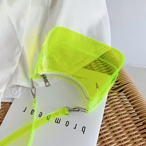 Close-up of fluorescent yellow transparent PVC hobo bag with silver metal zipper detail