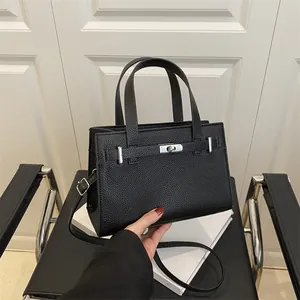 Litchi pattern black leather handbag with silver lock and adjustable shoulder strap