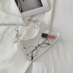 Detailed view of clear PVC half-moon bag with white zipper and metallic hardware