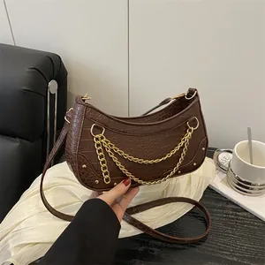 Dark brown crocodile embossed shoulder bag with gold chain and rivet details