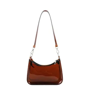 Detail view of transparent brown PVC hobo bag with silver zipper and sleek shoulder strap