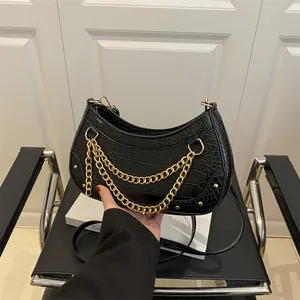 Chic black crocodile hobo bag with gold chains and adjustable shoulder strap