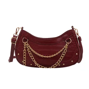 Burgundy faux crocodile shoulder bag with golden chain and metallic stud details
