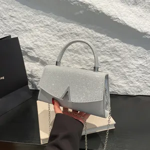 Silver rhinestone handbag with metallic logo, round handle and chain strap for women