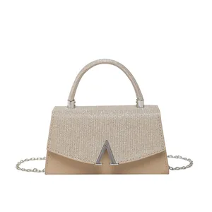 Champagne gold glitter handbag with metallic A-buckle and elegant chain strap for women