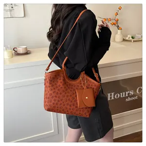 Brown tote bag set with floral patterns and matching mini pouch for women on a table