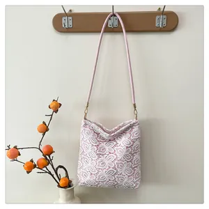Close-up of sweet floral lace embroidery and pink inner lining on a single shoulder bag