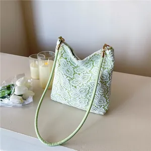 Minimalist light green lace bucket bag with floral crochet pattern and gold ring hardware