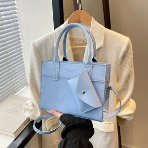 Light blue faux leather tote bag and mini pouch set with adjustable shoulder strap
