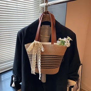 Woven straw bucket bag with floral lace bow and premium leather handles for beach