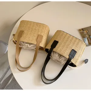 Straw tote bags with brown and black PU handles featuring drawstring inner lining
