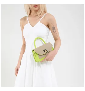 Detailed shot of contrast stitch handbag with gold D-buckle and neon green accents