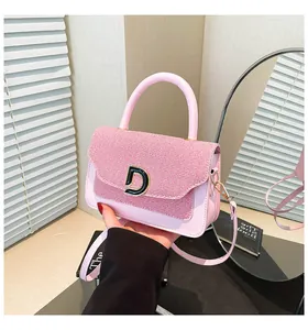 Detail of pink leather and textured fabric拼接 bag with gold-tone metal D buckle