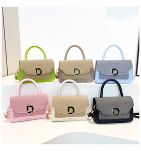 Close-up of six color variations of contrast texture handbags with metal D-buckle detail