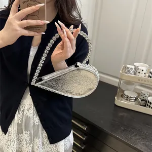 Silver heart-shaped evening clutch bag with sparkling rhinestones for party wear
