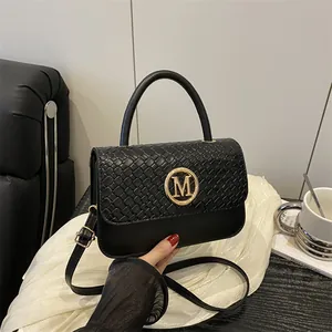 Fashionable black leather handbag with woven texture and gold M buckle for women