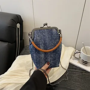 Vintage blue denim doctor bag with white dots, leather handle and metal chain strap