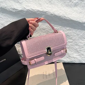 Chic pink glitter crossbody flap bag with gold twist lock and elegant leather top handle
