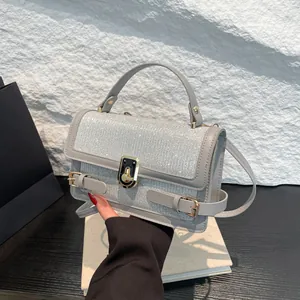 Gray leather crossbody bag with sparkling rhinestone flap and golden metal lock